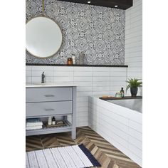 a bathroom with a sink, mirror and bathtub in it's center area