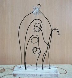 a wire sculpture is sitting on a table