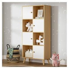 a wooden bookcase with white drawers in a child's room next to a pink toy horse