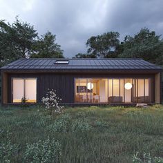 a small house in the middle of a field with trees and bushes around it at night