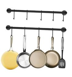 pots and pans are hanging on the wall in this kitchen rack with five hooks