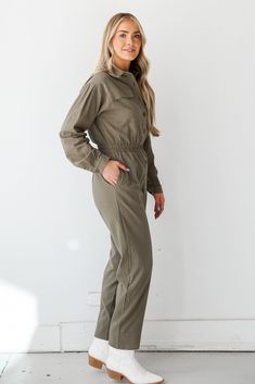 Prepare to leave everyone stunned by the way you strut in the Striking Attitude Olive Jumpsuit! This jumpsuit is designed to make a statement with its earthy olive hue, creating a look that is both effortlessly elegant and on-trend. Crafted from high-quality fabric, the olive jumpsuit offers a relaxed and comfortable fit, making it an ideal choice for various occasions. The rich olive color adds a touch of sophistication, allowing you to transition seamlessly from casual outings to more polished Khaki Overalls For Fall, Khaki Fall Overalls, Fall Season Khaki Overalls, Khaki Utility Jumpsuits And Rompers, Khaki Utility Jumpsuit For Work, Khaki Utility Jumpsuits And Rompers For Workwear, Utility Style Khaki Jumpsuit For Work, Khaki Utility Overall Jumpsuits And Rompers, Green Utility Jumpsuit For Workwear