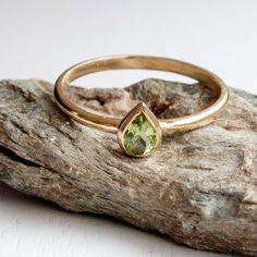 Green Peridot Gold Ring, Handmade to Order especially for you. This is a Ring to Hold on to and Cherish. Its a Dainty Gold ring with perfect symmetry A touch of Green Sparkle and Long smooth surfaces that round ever so comfortably around your finger, Featuring a Pear Shaped Cut untreated completely natural flawless Green Peridot gemstone. Weighing approx 0.55 Carat, 4 x 6 mm. Surrounded by Gold in your choice of Karat & Color. Rose Gold Highly recommended with this gemstone! The Band is on t Dainty Gold Ring, Dainty Gold Rings, Handmade Fine Jewelry, August Birthstone, Peridot Gemstone, Green Peridot, August Birth Stone, Pear Cut, Stackable Rings