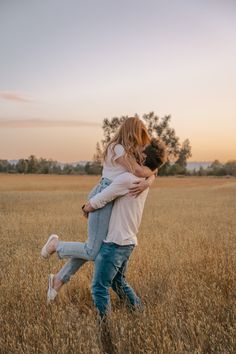 two people in a field hugging each other