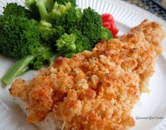 a white plate topped with fish and broccoli next to another piece of food