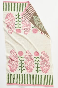 a pink and green blanket with flowers on it