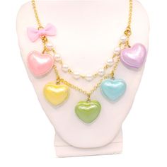 "A cute and sweet statement necklace for Valentine's Day or lovecore season! This kawaii charm necklace includes Five heart shaped macaron ( macaroon ) pendants in pastel shades with a pearly finish and whipped cream center. Each necklace includes five 1\" (2.5 cm) size charms hanging on a two-layered chain necklace with glass pearls on your choice of a 21\" gold plated or silver plated chain. Accented with a baby pink fabric ribbon bow on one side. Necklace will be finished with a Fatally Feminine Designs engraved heart charm. Closes with a lobster clasp. **Made to order - please allow 2 weeks for your item to be made before shipment** Matching Earrings and rings in my shop: https://etsy.com/shop/fatallyfeminine Every order comes with free gift packaging. Please contact me with any questi Multicolor Heart-shaped Kawaii Jewelry, Sweet Multicolor Heart-shaped Jewelry, Kawaii Multicolor Heart-shaped Jewelry, Kawaii Necklaces For Valentine's Day, Cute Multicolor Heart Shaped Necklace, Cute Multicolor Heart Necklace, Kawaii Style Necklaces For Valentine's Day Gift, Cute Multicolor Heart Charm Necklace, Kawaii Heart Beads Jewelry Gift