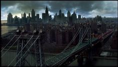 an aerial view of a city and bridge with dark clouds in the sky above it