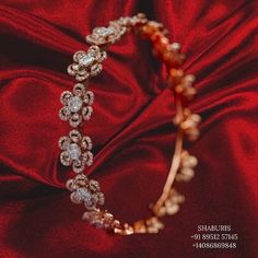 a close up of a bracelet on a red cloth