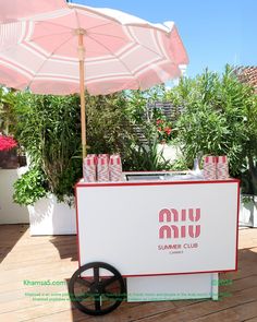 an umbrella and some drinks on a table