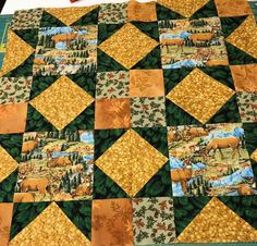 a quilted table topper with animals on it