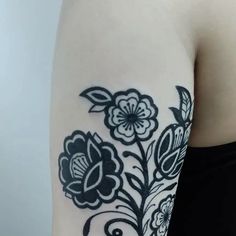 a close up of a person's arm with flowers on it