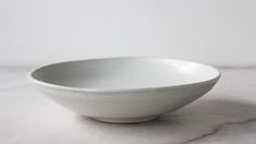 a white bowl sitting on top of a table