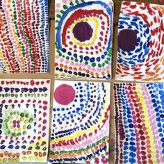 four different colored paintings with circles and dots on them, all painted in different colors