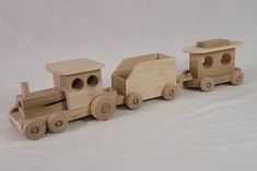 a wooden toy train is shown on a white background