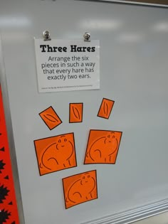 there is a sign that says three hares on the back of a refrigerator door