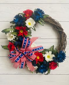 a patriotic wreath with red, white and blue flowers