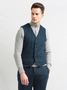 Its timeless quality makes this waistcoat well worth investing in if you have a penchant for classic Irish Design. Perfect for those days when it's too warm for a coat but you want an extra layer! Beautifully tailored for a perfect fit, six button closure and Blue Herringbone tweed with flecks of golden autumnal colours, it is perfect for an all year round appeal. Available Sizes in stock now: 38, 40, 42, 44, 46, 48 A stunning sea blue herringbone tweed vest 2 fully functional pockets 6 button f Winter Formal Vest For Business, Classic Blue Tweed Outerwear, Business Tailored Tweed Vest, Blue Wool Vest For Winter, Classic Blue Winter Vest, Formal Tweed Vest For Winter, Formal Winter Tweed Vest, Winter Business Tweed Vest, Blue Tweed Jacket With Welt Pockets