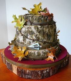 a three tiered cake decorated with leaves