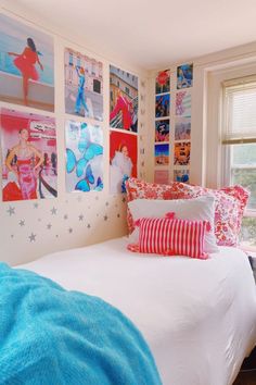 a bedroom with pictures on the wall and bed