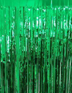 green tinsel is hanging from the ceiling