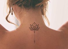 a woman with a lotus tattoo on her back