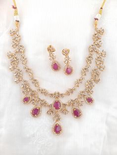 Rare Find Premium AD Studded Double Layered Necklace Set With Ruby Red Stones an elegance a must-have Statement necklace The stunning petite necklace's elegant leaf style can go with any outfit, enhancing the attire to give it a premium look. It's adorned with Ruby and premium AD stones giving it a graceful look. Please be advised of slight color variations due to light effects. Ruby AD necklace /polki Necklace / Indian Necklace/Indian Wedding Necklace/Indian jewelry Bridal SetIndian Choker/Indi Elegant Red Drop Necklace, Formal Red Necklace With Elegant Design, Red Necklaces With Elegant Design, Red Necklace With Elegant Design, Elegant Red Necklace, Indian Wedding Necklace, Petite Necklace, Red Stones, Polki Necklace