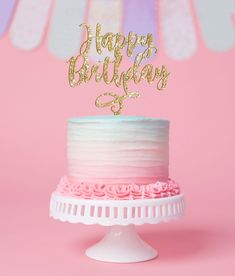 a pink and white cake with a gold happy 25th birthday topper