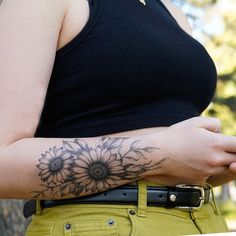 a woman with a sunflower tattoo on her arm