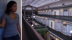 a woman standing next to an open balcony and looking down at the building's balconies