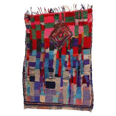 a multicolored patchwork rug with fringes