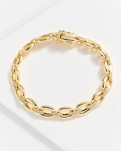 For a smooth and cultured style, choose the Gina Gold Chain Link Bracelet. Made with 14k gold-plated authentic sterling silver, the finish is one that shines with intensity. Chunky, oval-shaped links are connected with clear diamonette bedazzled bands to complete the look. With a double safety clasp to ensure it stays in place, this gorgeous piece exudes opulence for any occasion. By day, it adds a signature touch to your wardrobe while by night, it can bring out the elegance of any understated Elegant Gold Chain Bracelet With Diamond Accents, Gold Cubic Zirconia Link Bracelet, Gold Link Bracelet With Cubic Zirconia, Classic Gold Chain Bracelet With Diamond Accents, Modern Yellow Gold Oval Diamond Bracelet, Formal Oval Link Chain Bracelet With Diamond Accents, Gold Chain Bracelet With Diamond Accents For Everyday Luxury, Classic Gold Diamond Bracelet With Cable Chain, Luxury Oval Link Chain Bracelet For Anniversary