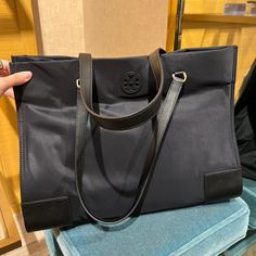 Tory Burch Black Ella Tote Ella Tote, Tory Burch Ella, Tory Burch Purse, Vinyl Bag, Tory Burch Tote, Tory Burch Bag Totes, Leather Camera Bag, Leather Satchel Bag, Blue Backpack