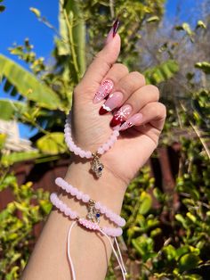 pink beaded protection adjustable bracelets with gold accents and cross charm. ✨ Pink Adjustable Charm Bracelet For Friendship, Pink Spiritual Charm Bracelet For Friendship, Pink Resizable Jewelry For Friendship, Pink Hand-strung Charm Bracelet For Gift, Adjustable Handmade Pink Rosary Bracelet, Pink Spiritual Friendship Bracelets, Pink Adjustable Spiritual Friendship Bracelets, Adjustable Pink Spiritual Friendship Bracelets, Pink Adjustable Rosary Bracelet For Friendship