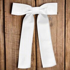 a white bow tied to a wooden door