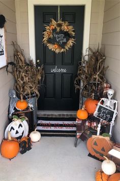 a front porch decorated for halloween with pumpkins and decorations