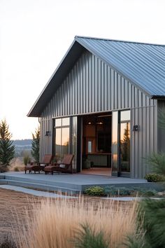 a house that has some chairs in front of it