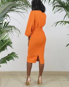 This Faux Wrap Midi Pencil Dress with Big Bishop Sleeve is perfect for any special occasion. Crafted from a luxurious blend of crepe this dress is comfortable to wear and hugs your body in all the right places. The orange hue adds a pop of color to any outfit while the midi cut and sleeved sleeves create a timeless silhouette. Perfect for weddings and parties. Product Features Please Compare your Measurements To our Size Chart Before Purchase Dress Comes With Same Fabric Waist Tie Belt Faux Wrap Formal Solid Color Sheath Bodycon Dress, Fitted Orange V-neck Midi Dress, Fitted Orange Sheath Dress, Elegant Solid Orange Dress, Elegant Orange V-neck Dress, Elegant Orange Solid Color Dress, Orange Fitted Knee-length Midi Dress, Fitted Solid Color Midi Dress For Brunch, Orange Bodycon Midi Dress For Party