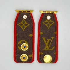 two brown and red leather bookmarks with gold accents