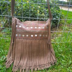 Light brown leather bag.Soft cow leather from Italy.Boho, hippie style.The bag, close with zipper and there are two pockets close with zipper.(inside and backside).                 Embroidered .The strap is adjustable to be worn on the shoulder or crossbody.                 DIMENSIONS.                    Height 37 cm,. Width 35 cm, depth 12 cm. Strap 1,49 cm                                   For more informations please contact me.Thanks for visit my shop. Bohemian Brown Shoulder Bag For Festival, Bohemian Fringed Satchel Shoulder Bag, Bohemian Beige Fringe Shoulder Bag, Bohemian Beige Fringed Shoulder Bag, Bohemian Leather Bag With Tassels, Bohemian Leather Shoulder Bag With Fringe, Beige Leather Bohemian Hobo Bag, Bohemian Brown Shoulder Bag With Fringe, Bohemian Fringe Hobo Shoulder Bag