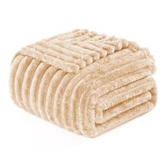 a pile of towels folded on top of each other in beige color, isolated on a white background