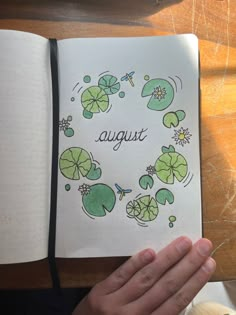 an open notebook with the words august written on it and shamrocks in a circle