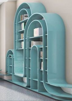 a room with bookshelves and shelves in the shape of archs on the wall