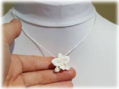 Petite hand sculpted 2.5cm white orchid necklace with faux pearl center. The handcrafted orchid pendant drops from on a hand wired bail. Available on silver gold or antique brass styles. -Original hand sculpted polymer clay flowers -Durable, water-resistant -No molds, no paint, no glue -Flower size : 2.5cm Flower (about 3/4 inch, size of a quarter) -Chain Length : Select 16 inch or 18 inch cable chain -Style : Select Silver-plated, Gold-plated, Antique Brass, 925 sterling Silver or 14k Gold Fill Black Rose Jewelry, Orchid Pendant, Water Nymph, Orchid Necklace, Orchid Jewelry, Orchid Wedding, Rose Jewelry, Polymer Clay Flowers, Jewelry Bridal