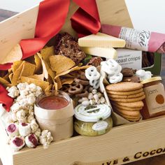 a wooden box filled with lots of food and condiments on top of a table