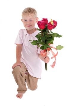 a young boy holding a bouquet of roses