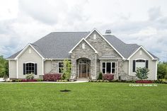 a large house with stone and shingles in the front yard