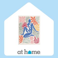 the logo for at home with an image of a woman sitting in front of flowers