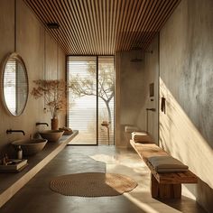 a large bathroom with two sinks, mirrors and a bench in front of the window