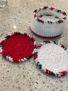 three crocheted baskets sitting on top of a counter